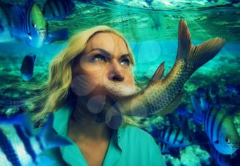 Woman's face smoothly changing to fishtail under the water