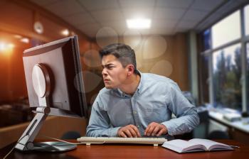 Young businessman working hard in the office with computer