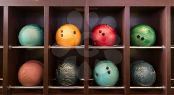 Bowling balls on the wooden shelf