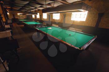Top side view of modern billiard saloon with table ready for play