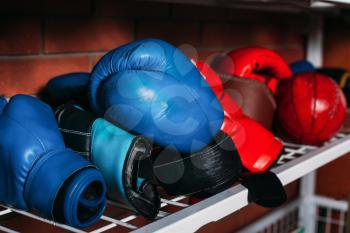 Boxing gloves on the shelf. Brick wall on the background. Boxing theme. Box equipment.