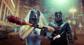 Bloody serial murederers newlyweds spending honeymoon. Bride in hockey mask with bat, groom with meat cleaver