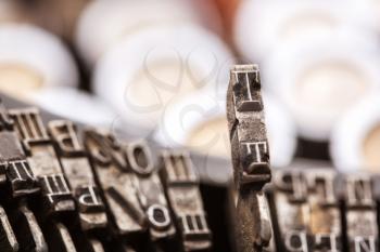 Retro writing machine type bars closeup. Vintage typewriter letters macro image