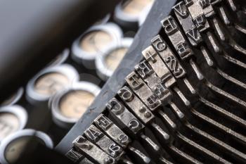 Vintage typewriter mechanism closeup image. Old type writer letters and type bars macro photo
