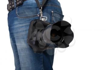 Male legs in jeans and belt holding gigital camera with professional lens on white background. Photo business concept