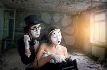 Pantomime theater actor and actress performing. Mime artists with white makeup masks on faces