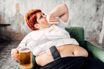 Overweight woman with glass of beer in hand, obesity. Unhealthy lifestyle, fatty female