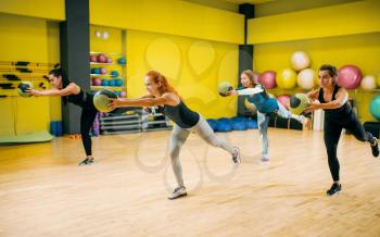 Women group with balls in motion, fitness workout. Female sport teamwork in gym. Fit exercise, aerobic
