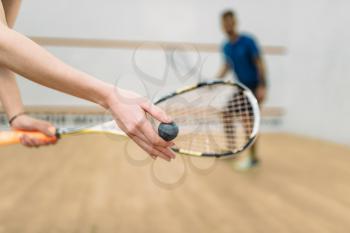 Young couple with rackets play squash game in indoor training club. Active sport lifestyle. Recreation workout, match with racquet