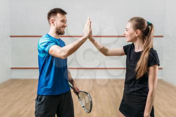 Squash players with rackets after match. Recreation workout. Active sport training. Game with ball and racquet
