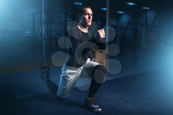 Athletic man on training, workout on press in gym. Active exercises in sport club