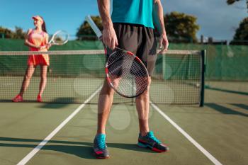 Man and woman plays tennis on open air. Summer season sport game. Active lifestyle