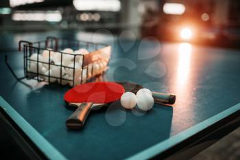 Ping pong table with rackets and balls in a sport hall, game equipment. Indoor tennis club