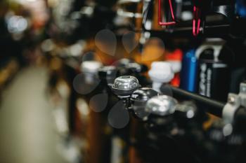 Bicycle equipment shop, new bike bells closeup, blur background. Accessories store, cycle sport