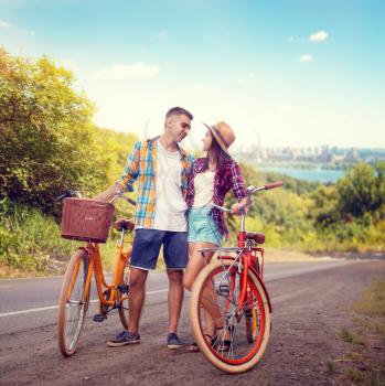 Love couple hugs on road, vintage bike, romantic travel of young man and woman. Boyfriend and girlfriend together outdoor, retro bicycle