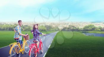 Love couple walk on vintage bikes, romantic journey of young man and woman. Boyfriend and girlfriend together outdoor, retro bicycle