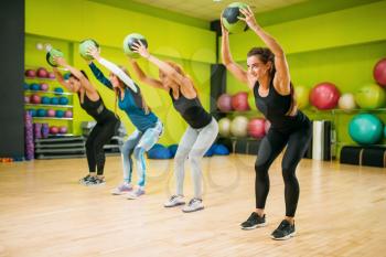 Women group with balls, fitness workout. Female sport teamwork in gym. Fit exercise, aerobic