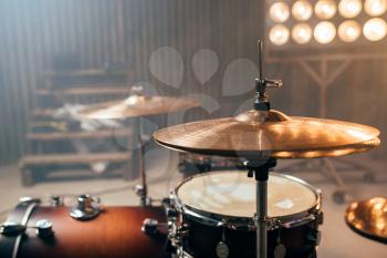 Drum-kit, drum-set, percussion instrument, drumkit on the stage with lights, nobody. Drummer professional equipment, beat set