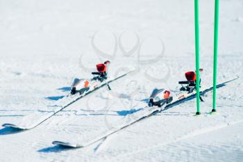 Skis and poles sticking out of the snow closeup, nobody. Winter active sport concept. Mountain skiing equipment