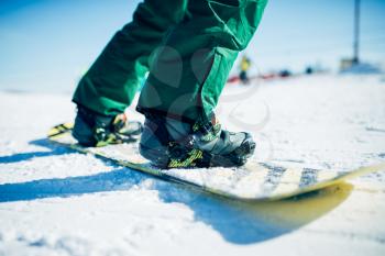 Snowboarder riding a snow hill. Winter extreme sport, active lifestyle. Snowboarding in mountains