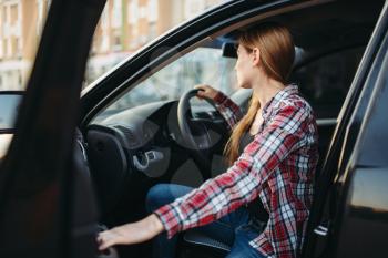 Female driver beginner sitting in a car. Woman in vehicle, driving automobile concept