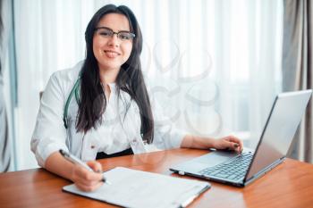 Family doctor concept, specialist sits at laptop. Professional health care