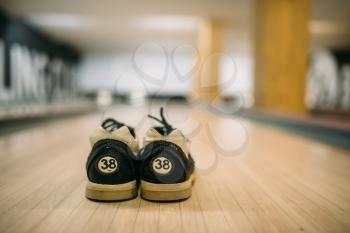 Bowling house shoes on lane in club, closeup view, nobody. Bowl game concept, active hobby