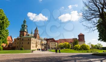 Group of tourists walking in Wawel castle, Krakow, Poland. European town with ancient architecture buildings, famous place for travel