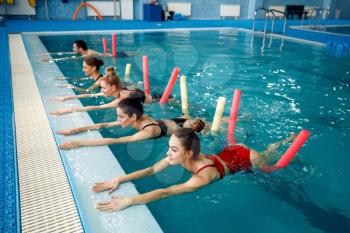 Female swimmers group, aqua aerobics training in the pool. Women in the water, sport swimming fitness workout