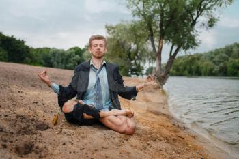 Office worker sitting on the beach in yoga pose, desert island. Business risk, collapse or bankruptcy concept