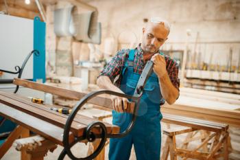Carpenter, wooden bench manufacturing, woodworking, lumber industry, carpentry. Wood processing on furniture factory, production of products of natural materials, joiner job