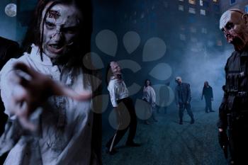 Zombies with bloody faces on night street in downtown, deadly monsters army. Horror in city, undead creepy crawlies attack, doomsday apocalypse