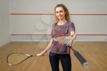 Female player gives squash racket. Girl on game training, active sport hobby on court, fit workout for healthy lifestyle
