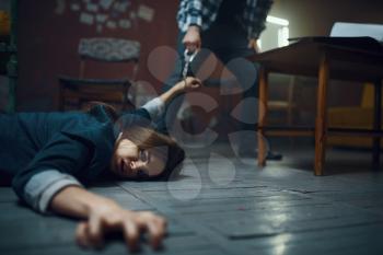 Maniac kidnapper drags his doomed victim across the floor. Kidnapping is a serious crime, crazy male psycho, kidnap horror, violence