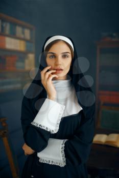 Young sexy nun in a cassock, vicious desires. Corrupt sister in the monastery, religion and faith, sinful religious people, attractive sinner