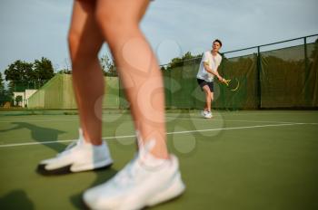 Man and woman on tennis training, outdoor court. Active healthy lifestyle, people play sport game, fitness workout with racquets