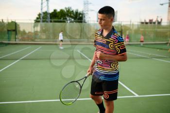 Centred male tennis player with rackets, training on outdoor court. Active healthy lifestyle, people play sport game, fitness workout with racquets