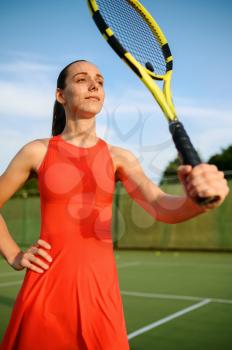 Attractive female tennis player with racket on outdoor court. Active healthy lifestyle, sport game competition, fitness training with racquet