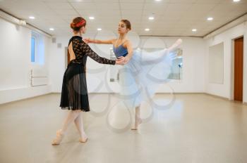 Choreographer works with young ballerina in class. Ballet school, female dancers on choreography lesson, girls practicing grace dance