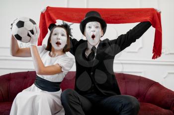 Two mime artists, football fans parody. Pantomime theater, comedian, positive emotion, humour performance, funny face mimic and grimace