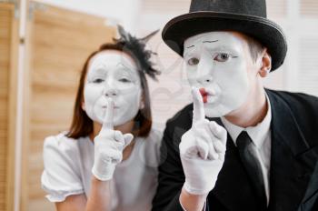 Two mime artists, secret gesture, parody. Pantomime theater, comedian, positive emotion, humour performance, funny face mimic and grimace