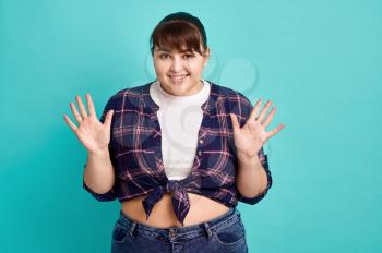 Funny overweight woman, body positive, blue background. Obesity fighting, cheerful female person without complexes