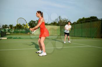 Man and woman on tennis training, outdoor court. Active healthy lifestyle, people play sport game, fitness workout with racquets