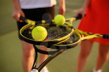 Mixed doubles tennis, players with rackets and balls, top view, outdoor court. Active healthy lifestyle, sport game training, fitness workout with racquets