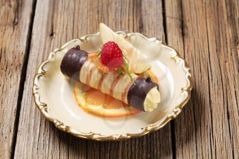 Cream filled wafer roll garnished with fresh fruit 