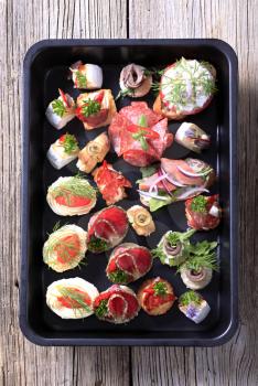 Assortment of hors d'oeuvre on a black tray