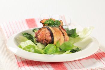 Meatball wrapped in courgette on nest of lettuce leaves