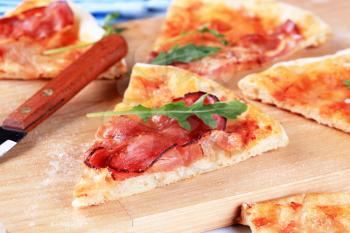 Slices of freshly baked pizza prosciutto