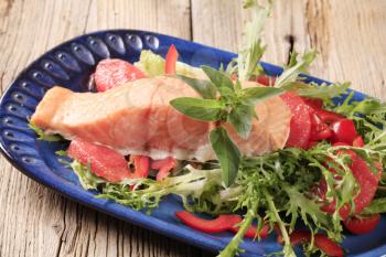 Salmon fillet on a nest of fresh salad