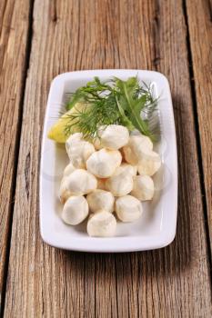 Fresh mozzarella cheese balls on a platter